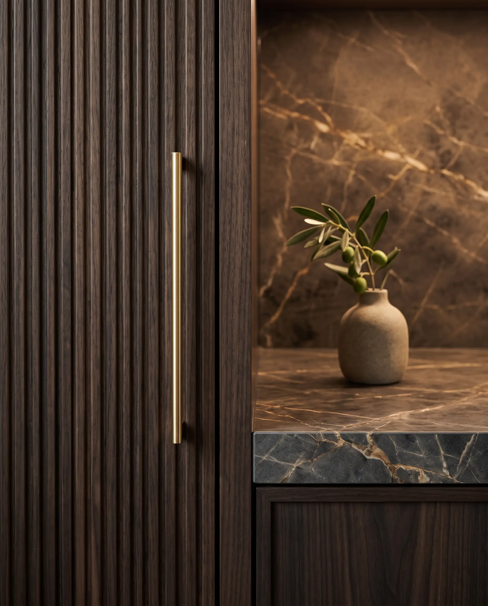 Finished walnut cabinet with brass handle beside a marble counter
